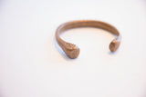 Close-up of the hand-worked texture and patina on the antique snake cuff.
