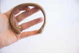 Side view of the antique snake cuff showing its curved form and hand-etched texture.