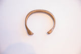 Collectible African snake cuff bracelet with a time-softened patina and incised marks.