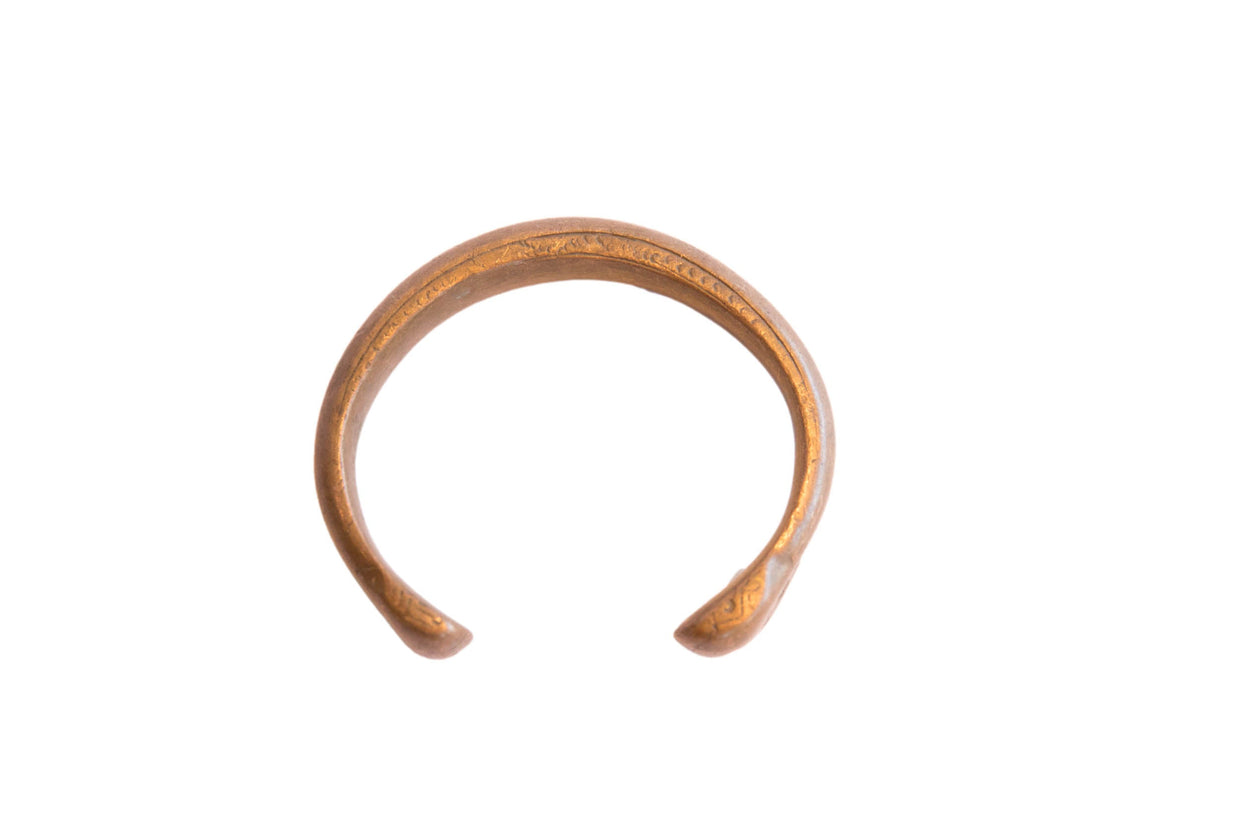 Antique African snake cuff bracelet with a warm, oxidized metal patina and open design.