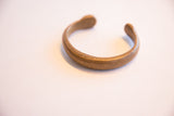 The warm patina and simple open form of the antique African cuff bracelet.