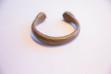 Profile of the antique snake cuff bracelet with an aged, hand-etched brass finish.