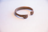 A view of the open ends of the antique African cuff with an aged patina.