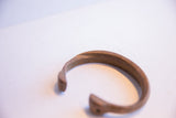 A close view of the antique cuff's open end, highlighting the hand-carved twist motif.