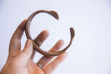 Antique African snake cuff bracelet displaying its open C-shape and time-softened patina.
