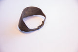 Close-up of the vintage African bracelet, showing its dark, textured surface with rich patina.