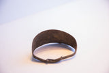 Vintage African bracelet close-up, revealing its rich, dark, textured patina.