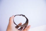 Close-up of the vintage African bracelet's rustic metal and aged patina.