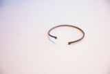 Vintage African thin cuff bracelet showing the twisted metal and open shape.