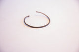 Close view of the twisted texture and dark patina on a thin African bracelet.
