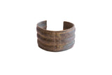 Vintage African wide cuff bracelet with a handmade, tiered design and rich, aged patina.