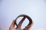 Side view showing the opening and interior of the vintage African cuff bracelet.