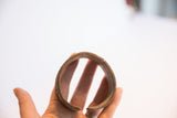 The open circular form and aged inner surface of a vintage African bracelet.