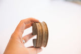 Vintage African cuff bracelet held to show its raised rope-like textural bands.