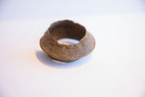 Angled view of the vintage African cuff bracelet's interior and textured, flared rim.
