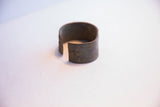 Detail of the hand-stamped motif and dark finish on the vintage African bracelet.