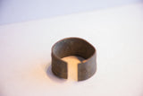 The wide opening and curved form of a vintage African cuff bracelet.