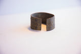 View of the vintage African cuff bracelet's open design and textured, oxidized finish.