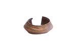 Vintage African cuff bracelet with a wide band, twisted rope detail, and aged patina.