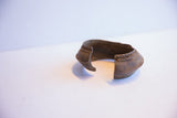 Side profile of the vintage African cuff showing its open shape and textured patina.