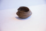 Angled profile of a vintage African cuff bracelet showing its substantial, curved form.