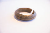 The aged metal patina and hand-etched line details of the vintage African cuff.