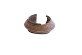 Vintage African cuff bracelet with a wide, flared form and a dark oxidized patina.