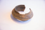 Angled view of the vintage African cuff's craftsmanship and time-worn metal patina.
