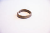 Vintage African cuff bracelet displaying its open shape and oxidized metallic surface.