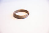 Angled view of the vintage African cuff bracelet showing its open end and etched details.