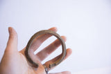 Vintage African cuff bracelet with a textured finish held in hand to show scale.