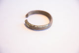 Etched markings and aged patina on the surface of the vintage African cuff.