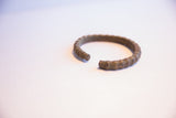 Ridged texture and solid metal ends of the vintage African cuff bracelet opening.