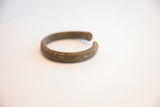 Profile view of the vintage African cuff showing its open shape and aged patina.