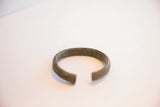 Angled view of the vintage African cuff bracelet highlighting its open form and aged patina.