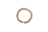 Vintage African cuff bracelet with a textured, hand-worked surface and a warm, aged patina.