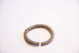 Angled view of the vintage African cuff showing its textured metal and open ends.