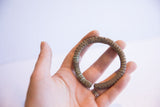 The three-dimensional form and ridged texture of a vintage African oxidized cuff.