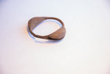 Side view highlighting the weathered patina and handcrafted C-shape of the Yoruba bracelet.