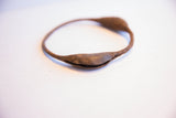 Close-up view of the aged, oxidized finish on a handmade rattle pod.