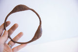 The scale and rustic, oxidized texture of a vintage Yoruba dance bracelet.