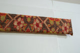 A detailed view of the rustic hand-knotted wool and geometric pattern on the Karabagh rug art.