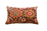 Vibrant vintage rug fragment pillow showcasing a detailed floral geometric pattern in ruby, gold, and teal.