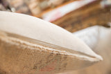 Pillow side with smooth zipper and textured vintage rug fragment.