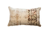Vintage rug fragment pillow, cream with earthy brown, green, and peach abstract pattern, 20x12.