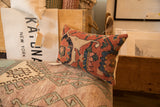 Antique Bijar rug fragment pillow with intricate hand-knotted rust and navy patterns.