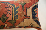 Hand-knotted pile of antique Bijar fragment pillow, displaying terracotta, indigo, and cream motifs.