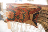 Aged hand-knotted texture and stylized motifs of the antique Bijar fragment pillow.