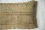 Woven texture and brown zigzag detail on a vintage Persian rug fragment pillow.