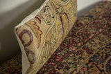Curvilinear saffron yellow and red art nouveau pattern detail on an Antique Kerman pillow.